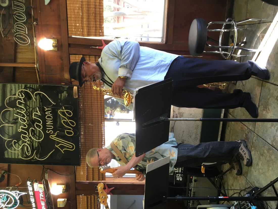 Ron Burris and a guitarist performing at the Sardine Can