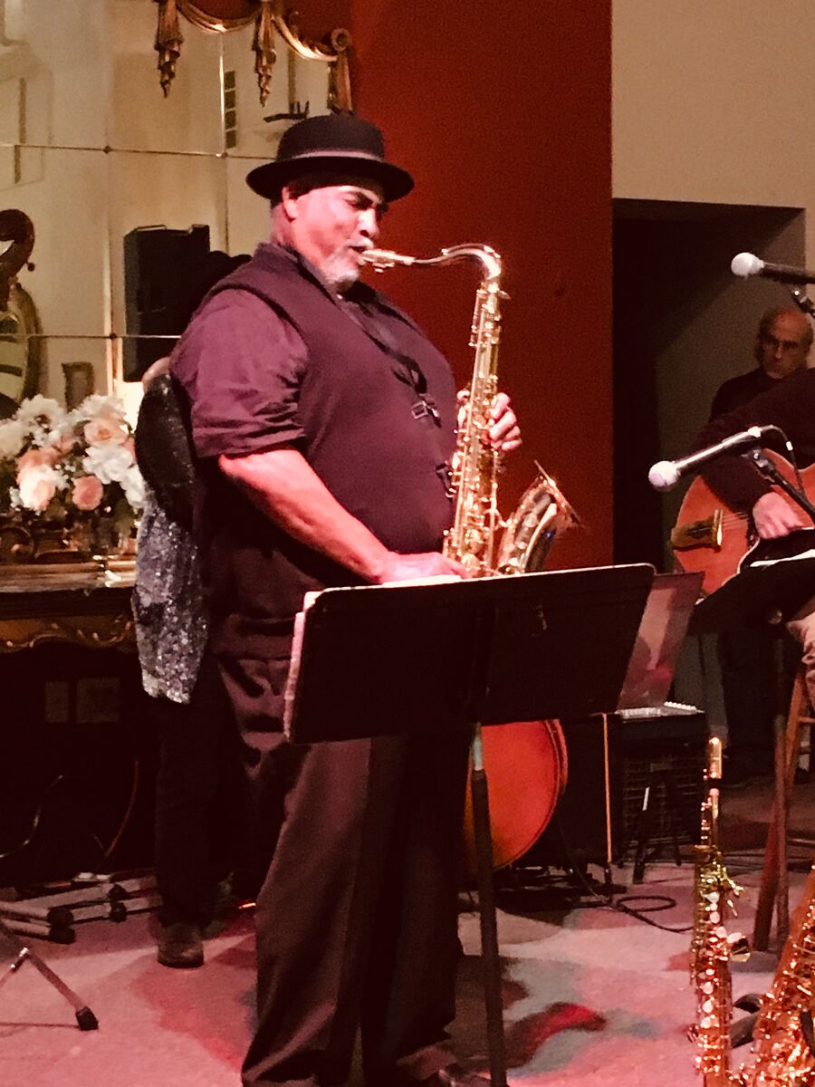 Ron Burris performing saxophone at a wedding reception